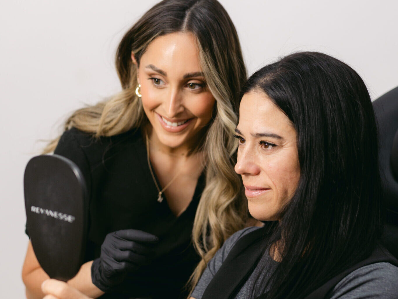 A nurse injector consulting with a client